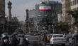A giant Iran flag is hanged from a state building in downtown Tehran on the eve of the Isl...