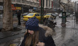 An Iranian woman walks along an avenue in downtown Tehran on the eve of the Islamic Revolu...
