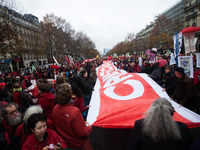 Climate demonstrators hold up a 100 meter long banner during the D12 demonstrations during the last day of COP21 on Avenue De La Grande Armé...