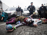 Clowns pretend to die with the planet in front of policemen during the D12 demonstrations during the last day of COP21 on Avenue De La Grand...