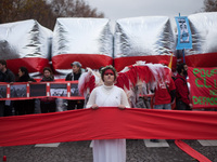 Guardian angel of the climate holds up a red line symbolizing panetary boundries in front of estimated 15,000 demonstrators during the D12 d...