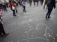 A protestor wrote "We are the nature" on the pavement when an estimated 15,000 demonstrators took to the streets and marsched from Avenue De...
