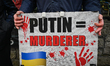 DUBLIN, IRELAND - FEBRUARY 12: An Irish peace activist holds a placard with words 'Putin...