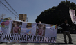 Demonstrators hold tarpaulins and banners a block away from the Mexico City Judiciary as t...