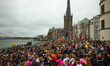 

A full pack of carnival revellers is seen partying along the Rhine River at Burgplatz Sq...