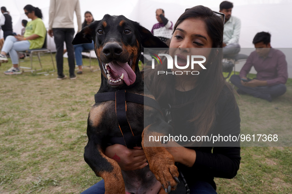 A woman plays with her dog during a show organized at one of the biggest pet-gathering events in Noida, on the outskirts of New Delhi, India...