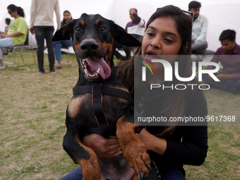 A woman plays with her dog during a show organized at one of the biggest pet-gathering events in Noida, on the outskirts of New Delhi, India...