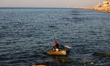 A Palestinian man fish with rods along the beach in Gaza City, on March 1, 2023.  