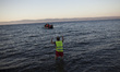 Refugees and migrants riding a dinghy reach the shores of the Greek island of Lesbos after...