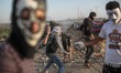 Palestinian protesters during clashes with Israeli security forces along the border with I...