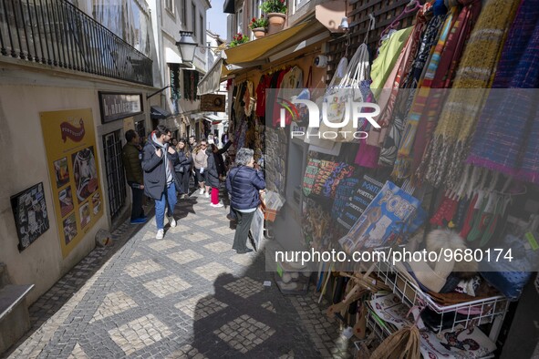 

People are seen walking through the streets of a street market in the historic area of Sintra, Portugal, on March 3, 2023. Sintra stands o...