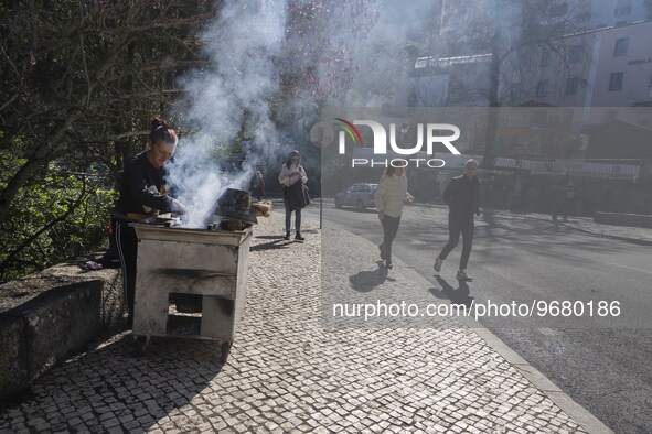 

People are seen walking near a chestnut seller located in one of the streets of the historic area of Sintra, Portugal, on March 3rd, 2023....
