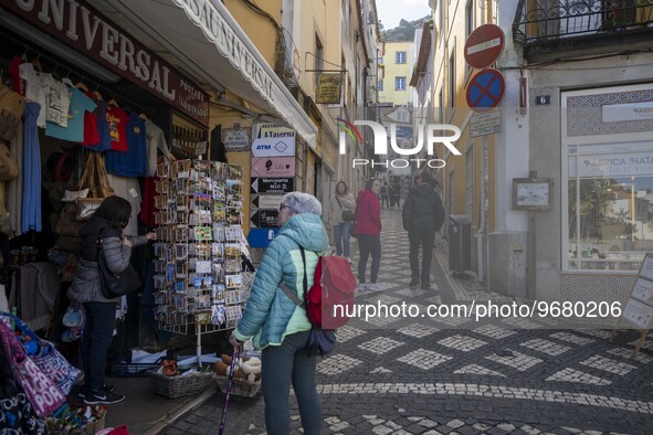 

People are seen walking through the streets of a street market in the historic area of Sintra, Portugal, on March 3, 2023. Sintra stands o...