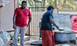 Men cook food to be distributed to Hindu devotees on the morning of the Attukal Pongala Ma...