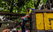 A worker loads bags of plastic waste into a garbage truck in Bogor, Indonesia, on March 4,...