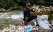 A small group of volunteers worked to clean up styrofoam from the Ciliwung River in Bogor,...
