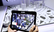  A congress visitor using a tablet to see a STC display of a smart city in augmented reali...