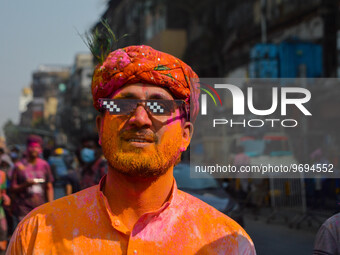 A man covered in colored powder poses for the camera during Holi festival celebration in Kolkata , India , on 5 March 2023 . Holi , also kno...