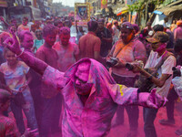 A man covered in colored powder is seen dancing on the street during Holi festival celebration in Kolkata , India , on 5 March 2023 . Holi ,...