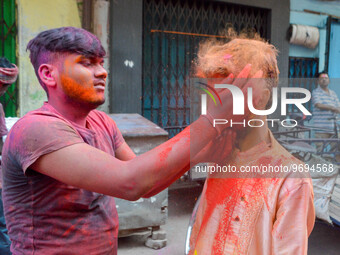 Two gboys are seen smearing each other with colored powder during Holi celebration in Kolkata , India , on 5 March 2023 . People of Kolkata...