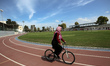 A Palestinian woman rides a bicycle at Gaza City's Yarmouk Stadium on March 7, 2023 a day...