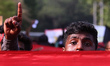 A university student participates in a protest  demanding the government withdraw the Prev...