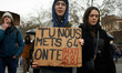 A young woman holds a placard reading 'You put 64 on us, we put May 68 on you'. France's l...