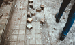 Paving stones are piled up on the sidewalk after clashes between Black Blocs and riot poli...