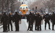 Riot police protect the trade union procession from the ongoing clashes with the Black Blo...