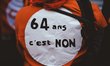 A demonstrator sewed a sign on the back of his orange sweatshirt reading ''64 years is no'...