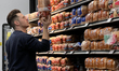 Man reads the ingredients on the package of a loaf of bread at a grocery store in Toronto,...