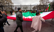 People carry a large Iranian flag by the White House during a protest against the Islamic...