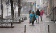 KYIV, UKRAINE - MARCH 12, 2023 - Pedestrians walk along a street as it is snowing in early...