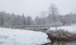 Snow covered landscape with the lake and building around in Park Meerland. Blizzard hits t...
