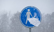 A pedestrian sign covered by snow. Blizzard hits the Netherlands and Belgium during a low...