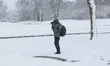 A man is taking pictures with his camera of the winter snowcovered landscape. People seen...