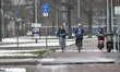 People as seen cycling their bicycle during the freezing temperatures and snow condition i...