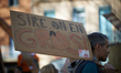 A man holds a cardboard reading 'Majesty, we are fed up'. France's labour unions and left...