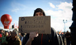A protester holds a placard 'Radical democracy: referendum or dissolution'. France's labou...
