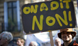 A protester holds a placard 'We say NO !' France's labour unions and left parties led a 8t...