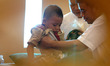 JAKARTA, INDONESIA, DEC 27: Dad helped carry her child after having a free mass circumcisi...