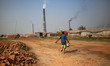 A child is carrying dringking water for brickyard worker.The world is going through a spe...
