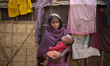 Child marriage also very common among brick yard workers. ROJINA is a young mother holding...