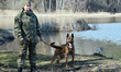 KYIV REGION, UKRAINE - MARCH 15 , 2023 - A dog handler with a police dog is seen at the pr...