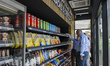 Customers pick up grocery items after opening Qatars first fully autonomous and checkout-f...