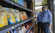 Customers pick up grocery items after opening Qatars first fully autonomous and checkout-f...