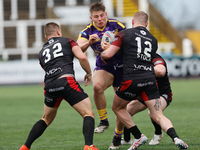Connor Moore of Newcastle Thunder is tackled by Jacob Jones of London Broncos and Marcos Stock of London Broncos during the BETFRED Champion...