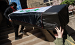 Demonstrators carry symbolic body caskets into The New York Avenue Presbyterian Church dur...