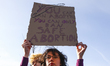 A woman holds a banner during an annual 'Manifa' march in Krakow, Poland on March 18, 2023...