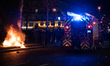 CRS escort a fire truck to put out a fire started by demonstrators during a rally called b...